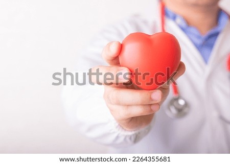 Doctor holding or showing red heart, concept for health or repair and support, international, national heart disease day, doctor day, world health day Royalty-Free Stock Photo #2264355681