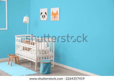 Interior of modern nursery with white baby crib