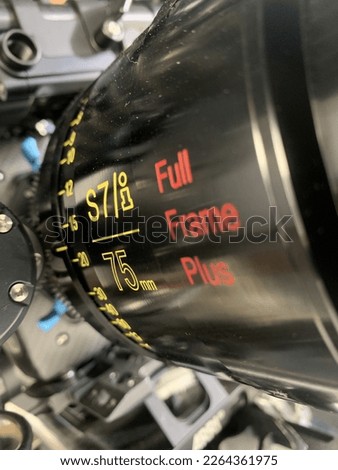 Full Frame Cinema Lens with yellow and red fonts and black body colour.