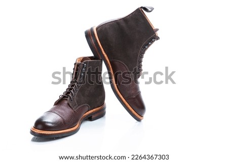 Premium Dark Brown Grain Brogue Derby Boots Made of Calf Leather with Rubber Sole Placed on One Another Over White Background. Horizontal Image Orientation