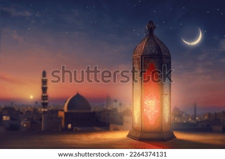 Ornamental Arabic lantern with burning candle glowing at night mosque background. Festive greeting card, invitation for Muslim holy month Ramadan Kareem. Royalty-Free Stock Photo #2264374131