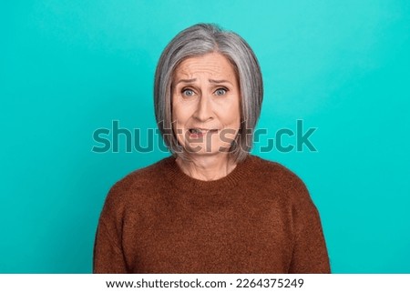 Portrait of unsatisfied nervous person biting lips worrying isolated on turquoise color background Royalty-Free Stock Photo #2264375249