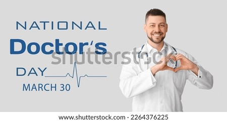 Male cardiologist making heart with his hands on light background. National Doctors Day Royalty-Free Stock Photo #2264376225
