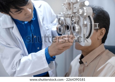 Optometrist uses ophthalmological diagnostic equipment to test the vision of an elderly man, Professional medical machine, diagnostic ophthalmology equipment, selective focus 