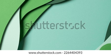 Abstract green color paper texture background. Minimal paper cut style composition with layers of geometric shapes and lines in green tone shades. Top view Royalty-Free Stock Photo #2264404393