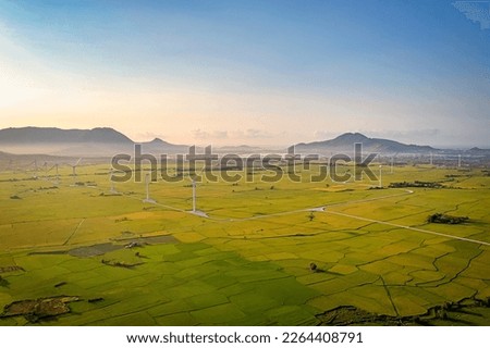 Panoramic view of wind farm or wind park, with high wind turbines for generation electricity with copy space. Green energy concept. Ninh Thuan, Vietnam Royalty-Free Stock Photo #2264408791