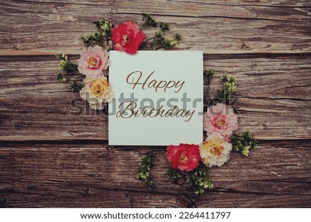 Happy Birthday typography text decorate with flower on wooden background