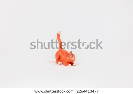 a cat figure children's toy on a white background