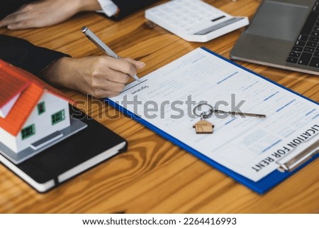 Real estate agent businessman signing a house rental agreement.
