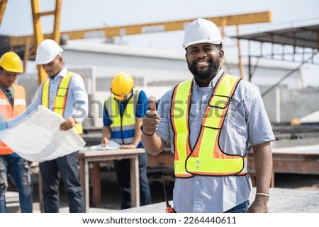 Portrait African American engineer man thump up with team working with paper work and precast cement factory background	 Royalty-Free Stock Photo #2264440611