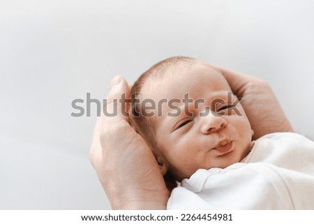 Close up of caucasian hairy brunet cute newborn baby sleeping.One or two week child in male hands.Unrecognizable man, father,holding child.Care,love,happiness concept. Royalty-Free Stock Photo #2264454981