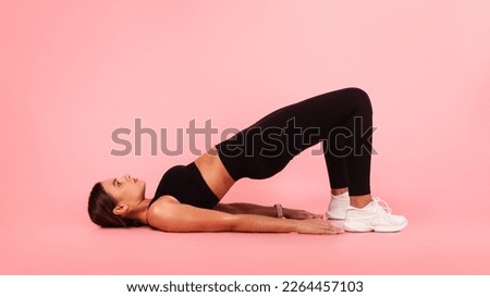 Fitness Concept. Sporty Young Female In Activewear Doing Glute Bridge Exercise, Athletic Woman Training Buttocks And Leg Muscles, Working Out Over Pink Background In Studio, Copy Space Royalty-Free Stock Photo #2264457103