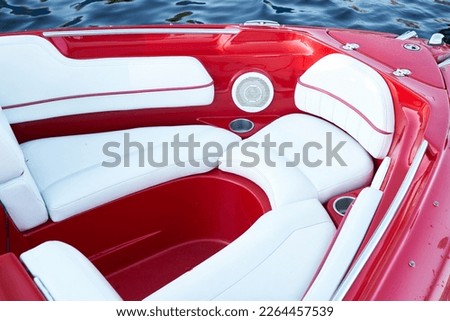 Сlose-up of the red speedboat bow with white leather seats                             Royalty-Free Stock Photo #2264457539