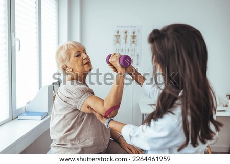 Female physiotherapists provide assistance to senior female patients with elbow injuries examine patients in rehabilitation centers. Rehabilitation physiotherapy concept. 