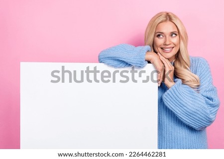 Photo of positive lovely lady wear trendy blue pullover demonstrate empty space interesting offer isolated on pink color background