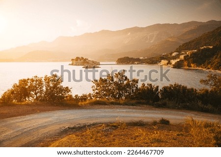 A peaceful view of small islet Sveti Stefan in the evening light. Location place Montenegro, Adriatic sea, Balkans, Europe. Image of popular tourist destination. Discover the beauty of earth.