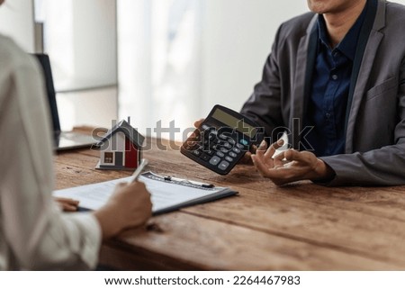 Close up Business man or Real Estate agent explain signing agreement for buying house. Bank manager and real estate concept