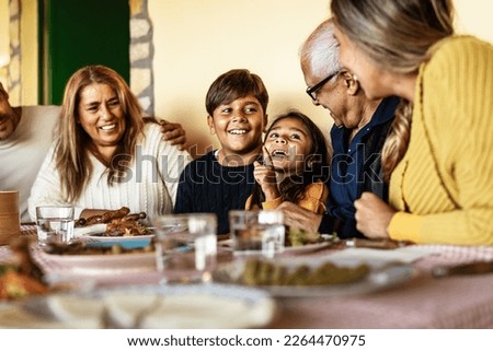 Happy Latin family having fun lunching together at home Royalty-Free Stock Photo #2264470975