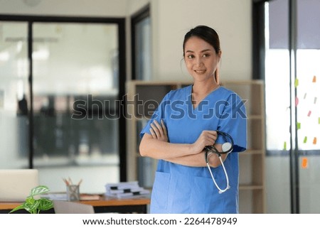 Woman doctor in white uniform holding stethoscope in hand. Healthcare and medical concept.