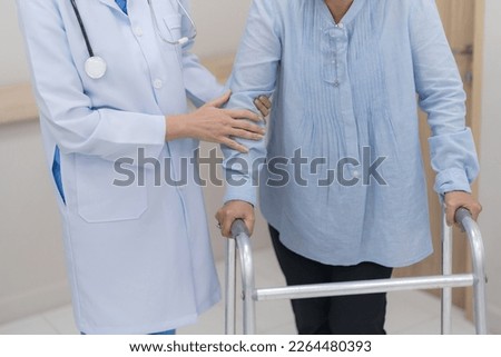 Doctor introducing treatment to patient, Physician supporting senior woman on the arm and walking outside.