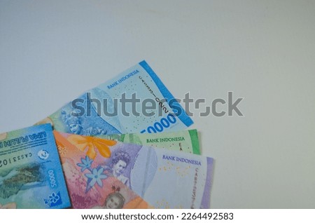 The new style of rupiah currency is arranged on a white background to form a unique shadow.