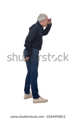side view of standing man looking  with hand on forehead on white background