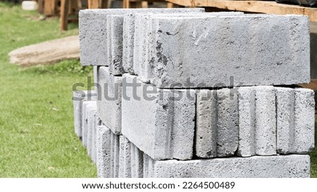Cement bricks are the basic material for building houses and other buildings Royalty-Free Stock Photo #2264500489