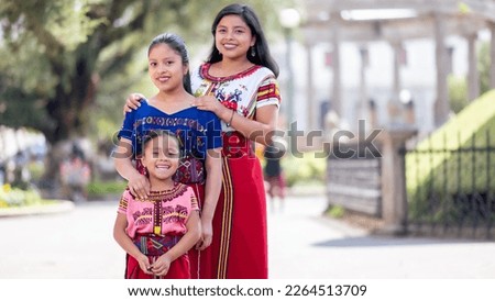 Portrait of 3 happy young women in the park in Quetzaltenango looking at the camera. Royalty-Free Stock Photo #2264513709