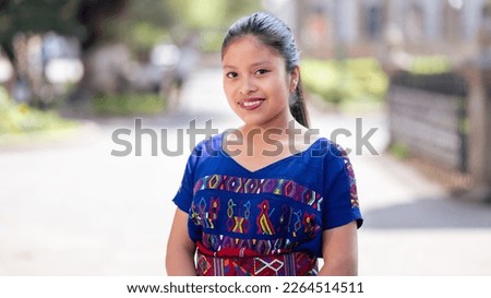 Portrait of beautiful girl dressed in a beautiful typical blue costume. Royalty-Free Stock Photo #2264514511