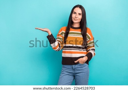 Photo of sweet shiny woman wear striped sweater showing arm empty space isolated turquoise color background