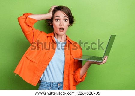 Photo of worried nervous stressed depressed lady wear orange stylish clothes hold broken new device isolated on green color background