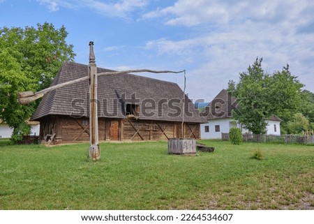 Stunning old white Hungarian farmhouse and wooden shed.
