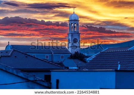 Kastela, Split-Dalmatia, Croatia. Church bell tower against the backdrop of the setting sun