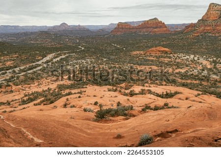 Views of red rock buttes and formations within coconino national forest in Sedona Arizona USA against white cloud background. Horizontal Image.