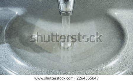 Water flows from the tap in airplane Royalty-Free Stock Photo #2264555849