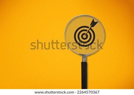 Magnifier glass focuses on image of target icon.