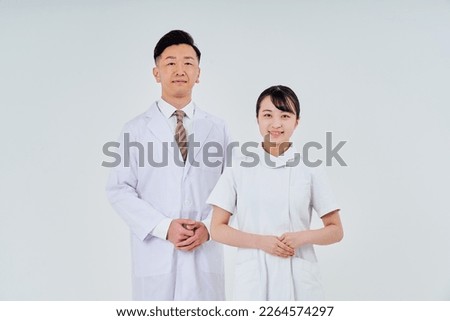 Man and woman in white coats   Royalty-Free Stock Photo #2264574297