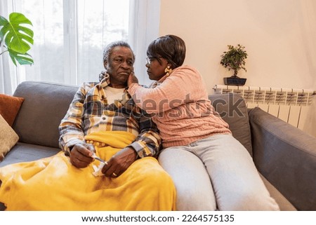 senior couple, sick man, his wife takes care of him