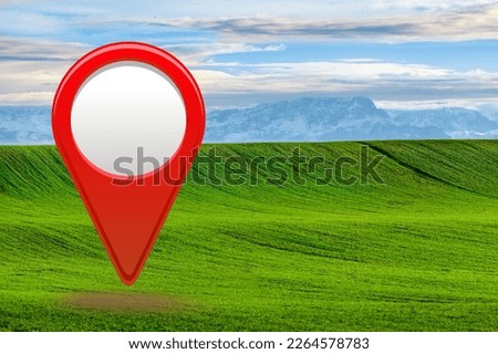 Big field with blue sky and big location red pin