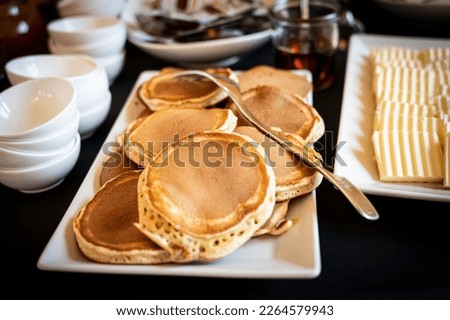 Pancakes in buffet for breakfast with honey and butter. Royalty-Free Stock Photo #2264579943