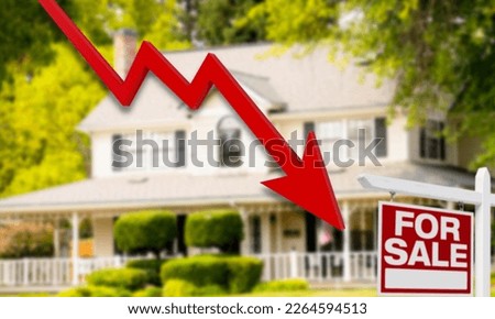 Descending arrow over a house for sale indicating a drop in the price