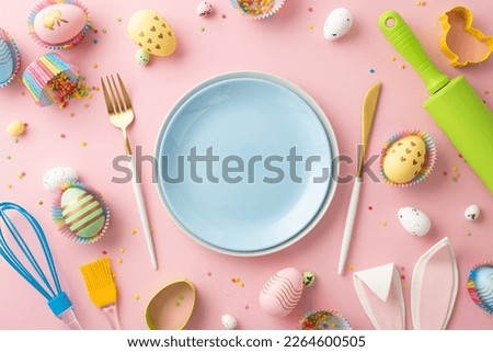 Easter celebration concept. Top view photo of empty blue dishes knife fork rolling pin whisk colorful easter eggs in paper baking molds bunny ears and sprinkles on isolated pastel pink background