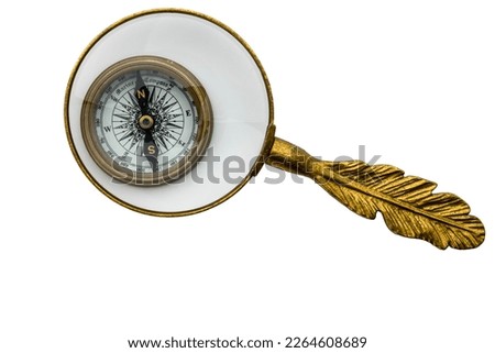 Vintage look compass under magnifying glass, isolated on white background, concept of examining direction in life, clipping path