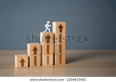 Man climbs the stairs to success. Movement towards the goal. Step by step. New opportunities. Get to the top. Set a target and find ways to achieve it. Motivation, self-development. Royalty-Free Stock Photo #2264615461