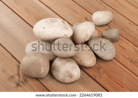 Rocks, natural stones pile on wooden desk