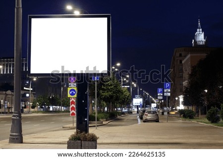 Large horizontal billboard in the night city. Dark blue sky, the lights of the lanterns go into the distance. Mock-up.