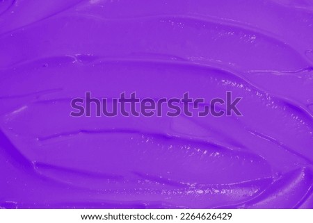 purple cream texture photographed from above for cosmetics background