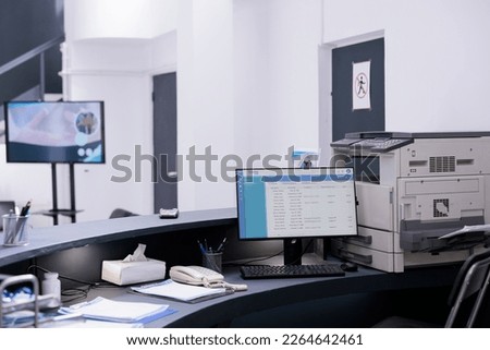 List of patients appoinments displayed on desktop computer screen on registration counter of health facility. No one in hospital waiting area, medicine support service and concept Royalty-Free Stock Photo #2264642461