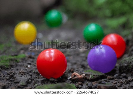 Photo of colorful balls on the ground with a blurred background