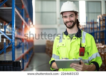 Professional heavy industry woman engineer worker wearing safety uniform and hard hat, Using tablet computer. Logistics and transporter concept.